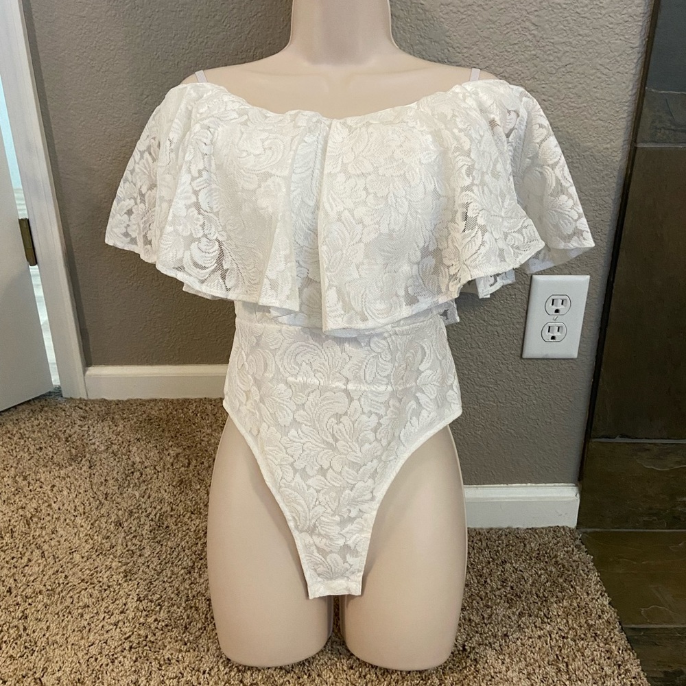 Lace ruffle bodysuit. Great color for spring and summer. Never been worn.